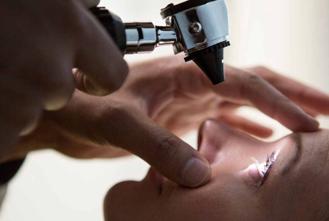 A person is getting their teeth cleaned by an eye doctor.