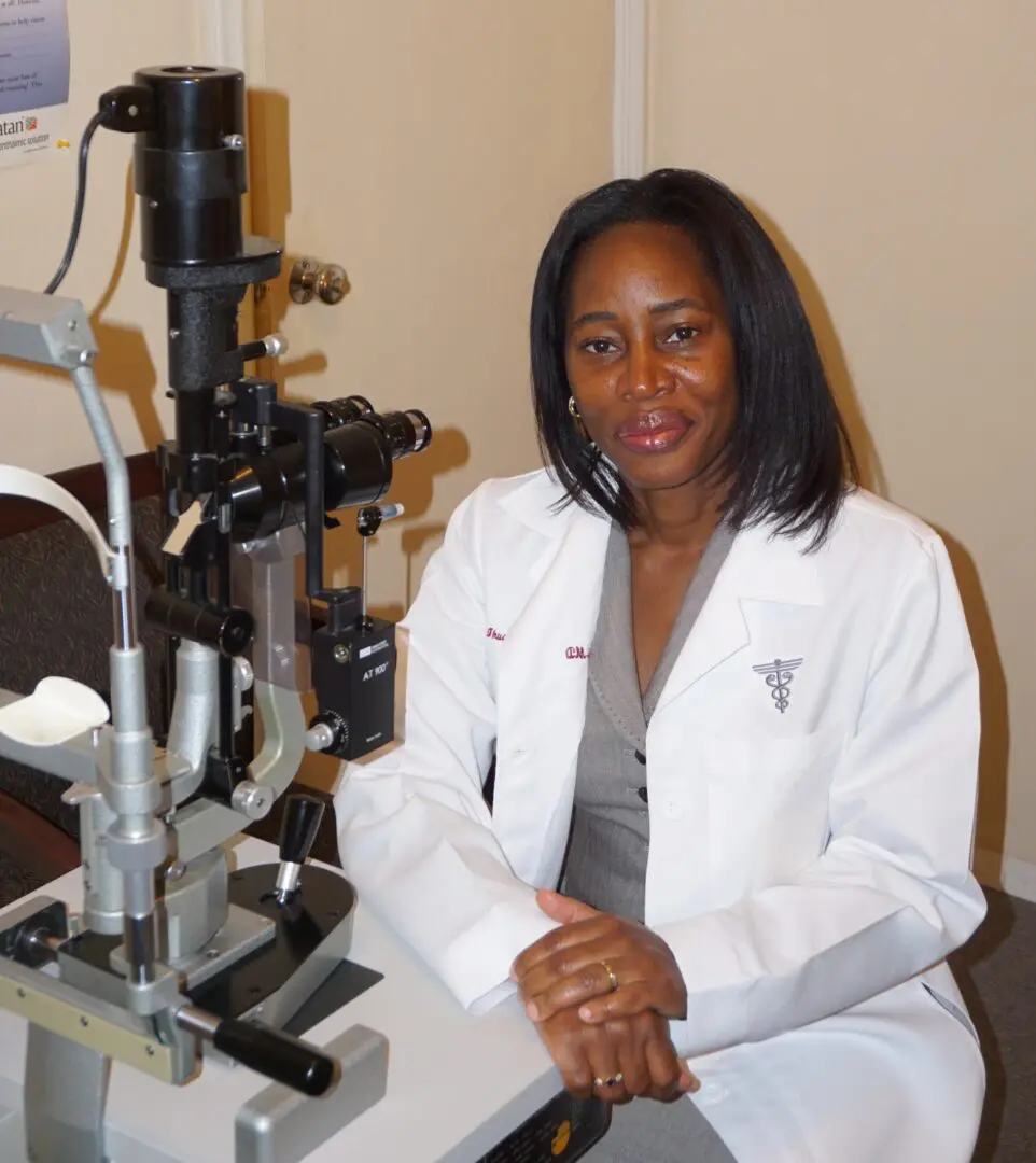 A woman sitting in front of an eye exam machine.