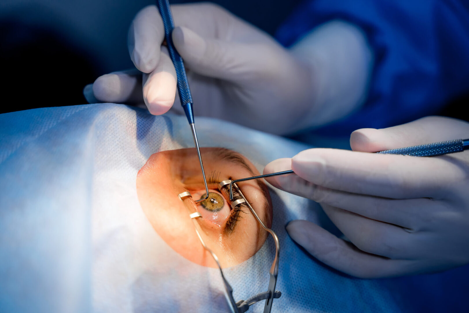 A person is holding scissors and wires in their mouth.