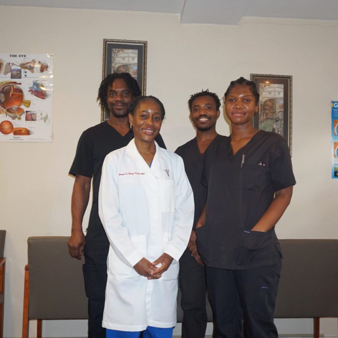 A group of doctors standing in front of a wall.