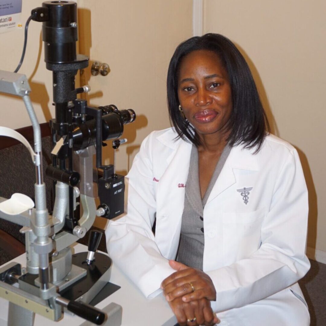 A woman sitting in front of an eye exam machine.